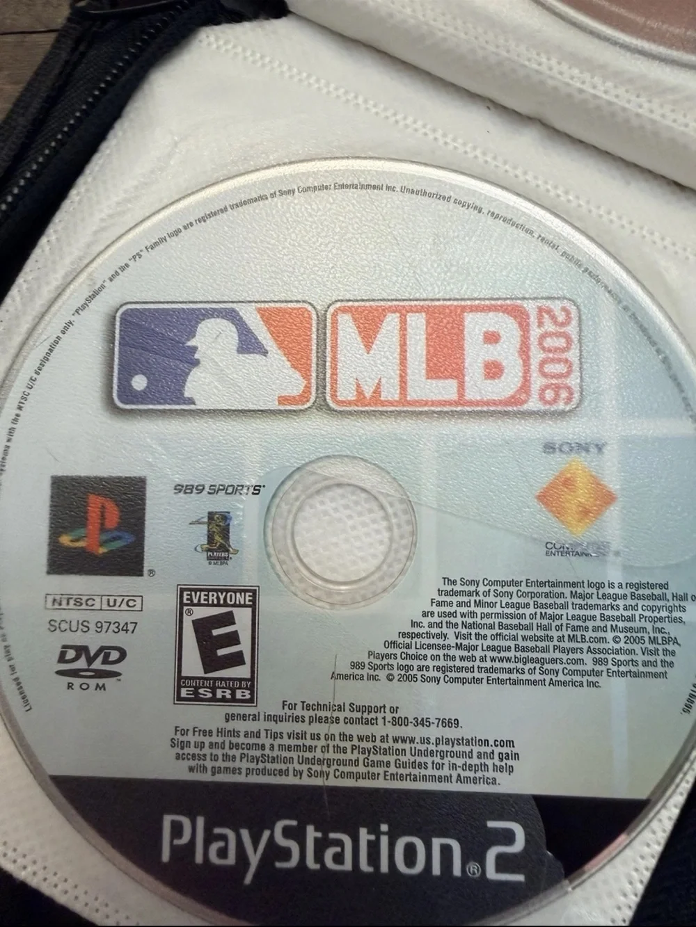 13 Disc Lot: 11 PS1 / Sony PS2 Games + 2 DVDs in Green Storage Binder Case